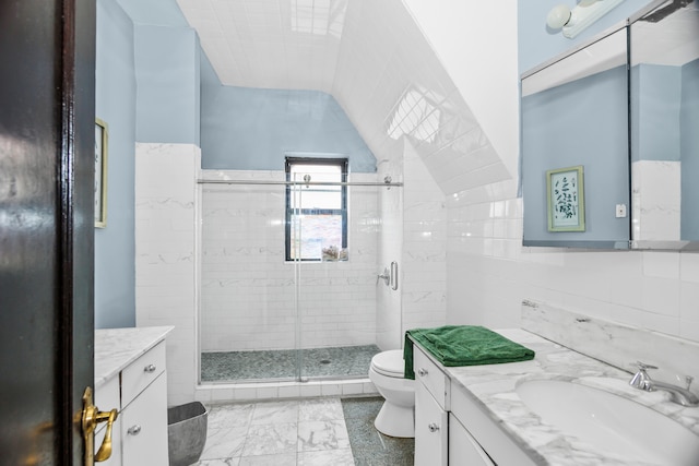 bathroom featuring walk in shower, vanity, tile walls, and toilet