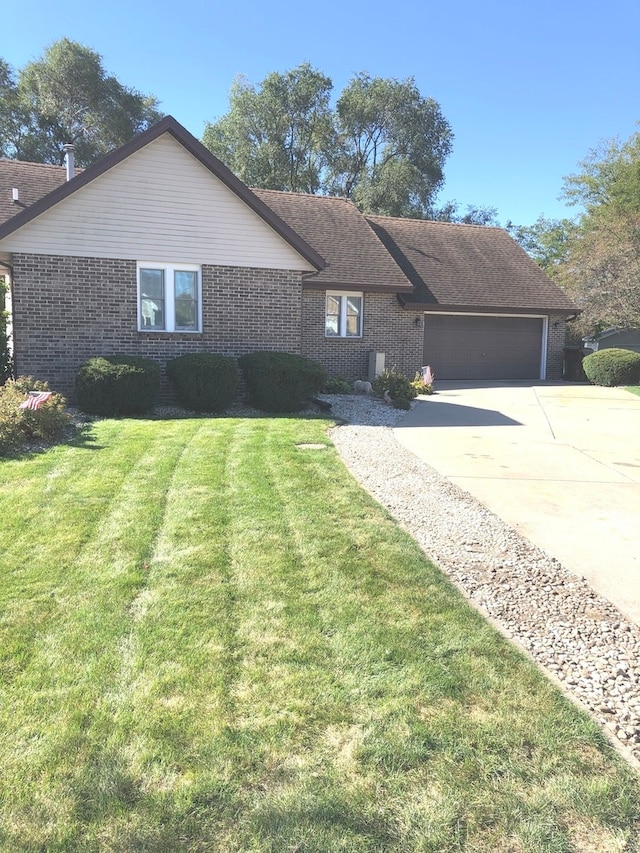 single story home with a front yard and a garage