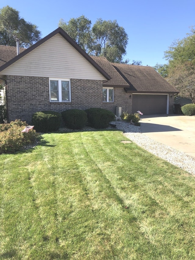 ranch-style home with a front yard and a garage