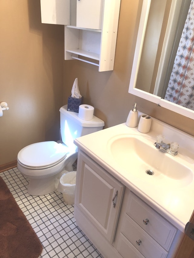 bathroom with vanity, toilet, and tile patterned floors