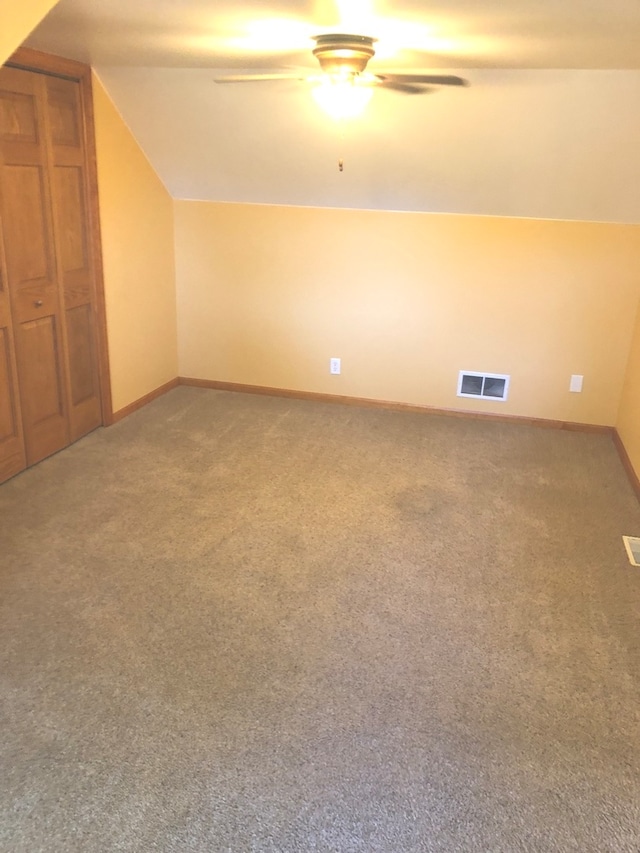 additional living space with ceiling fan, carpet flooring, and lofted ceiling