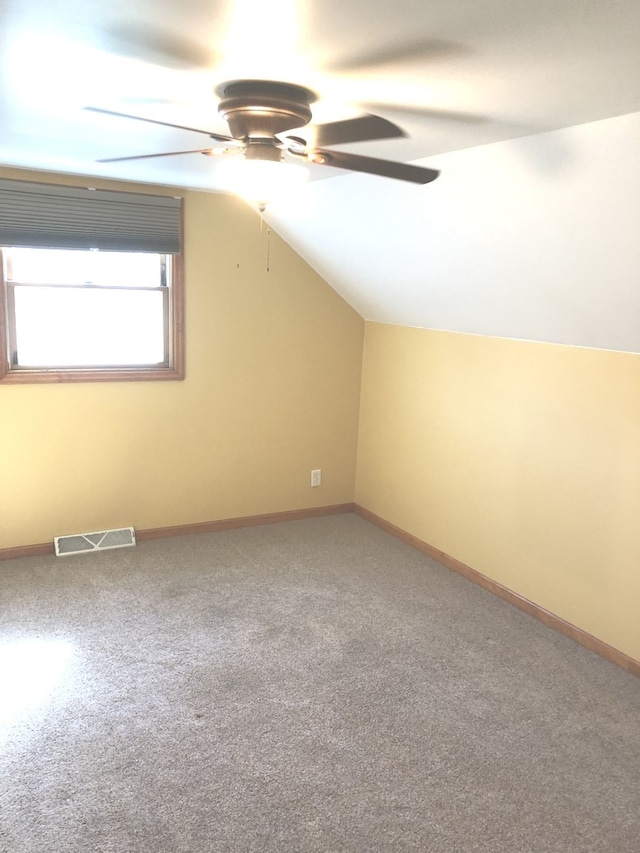 additional living space featuring ceiling fan, vaulted ceiling, and carpet floors