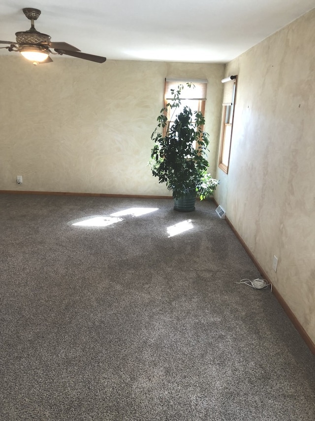 carpeted spare room with ceiling fan