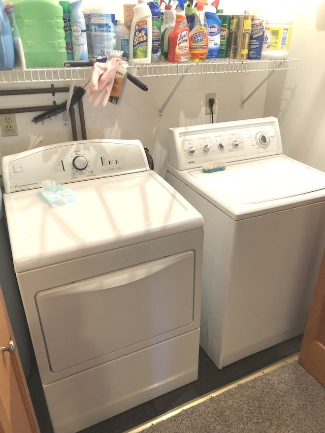 washroom with dark hardwood / wood-style floors and washer and clothes dryer