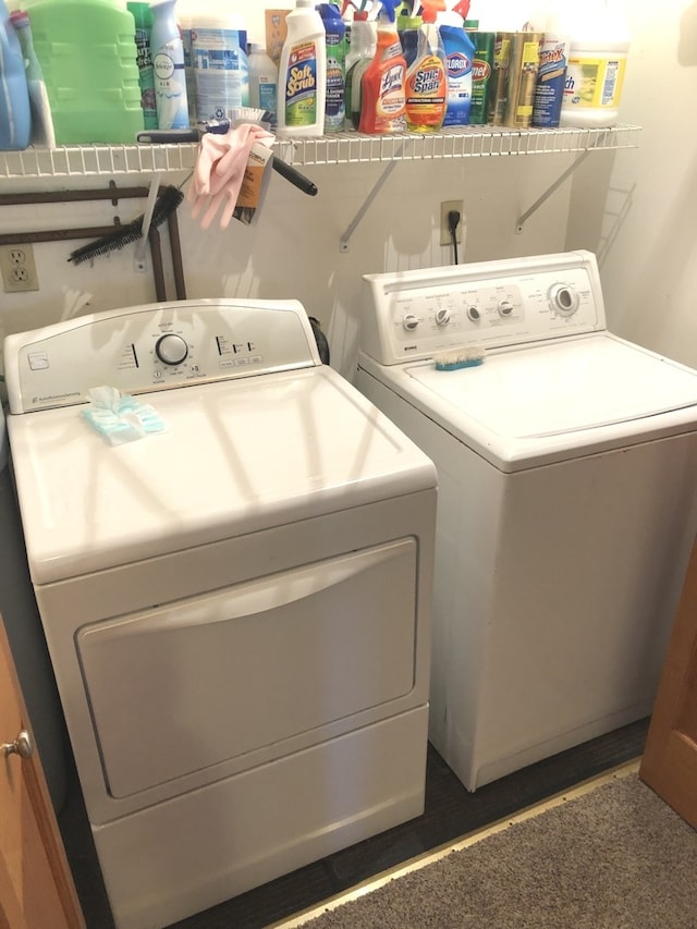 laundry area with dark wood-type flooring and independent washer and dryer