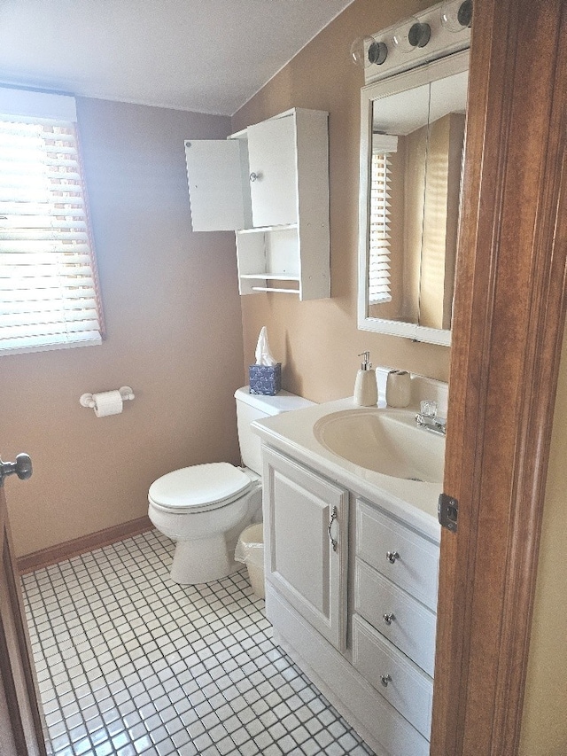 bathroom with toilet, a textured ceiling, vanity, and tile patterned flooring