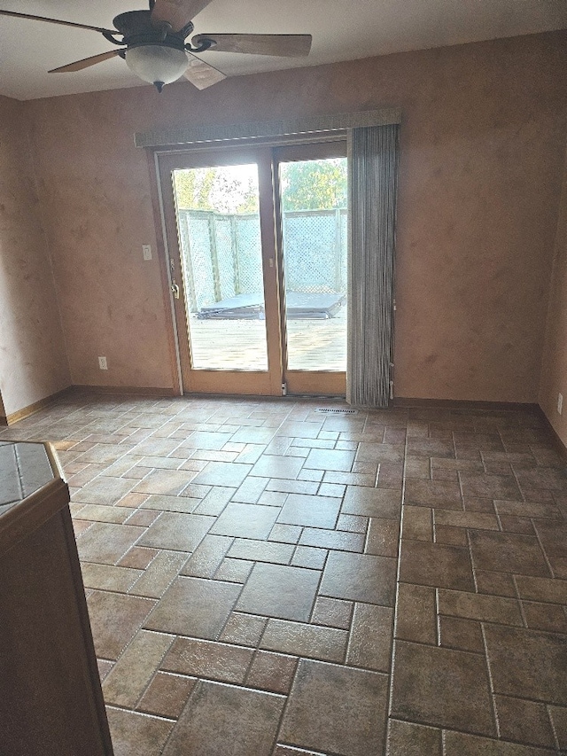 unfurnished room featuring ceiling fan