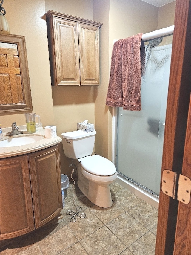 bathroom with vanity, toilet, tile patterned floors, and an enclosed shower