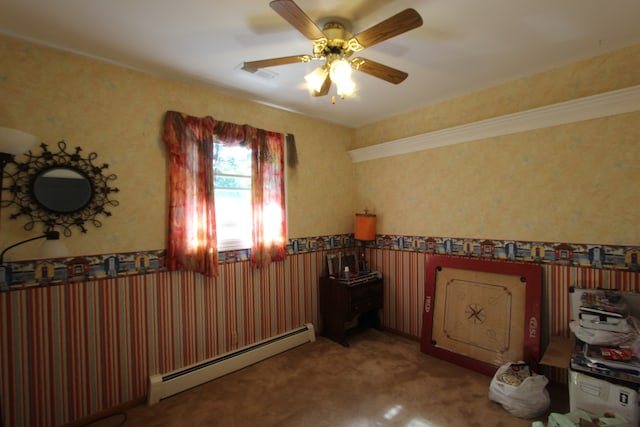 spare room with baseboard heating, carpet, and ceiling fan