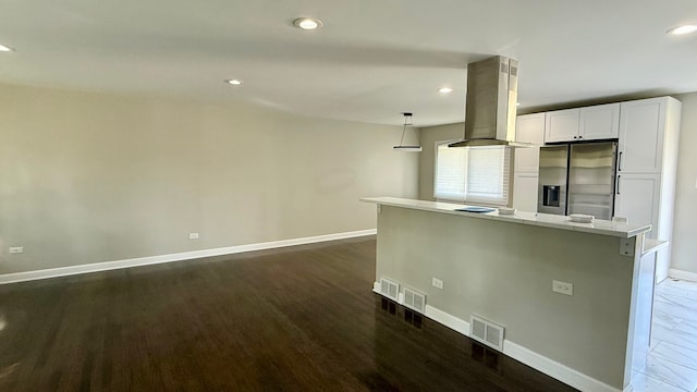 kitchen with decorative light fixtures, dark hardwood / wood-style floors, stainless steel fridge with ice dispenser, island range hood, and white cabinetry