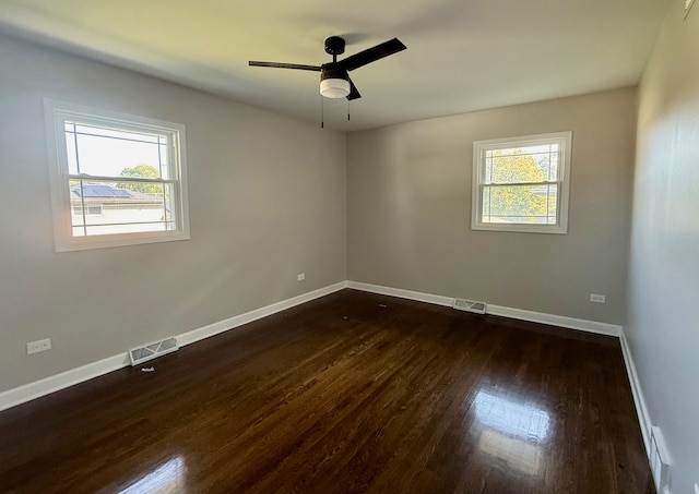 unfurnished room with ceiling fan and dark hardwood / wood-style floors