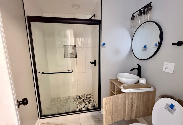 bathroom with toilet, vanity, and an enclosed shower