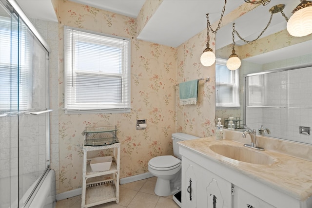 full bathroom with combined bath / shower with glass door, vanity, toilet, and tile patterned floors