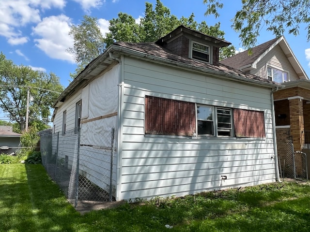 view of property exterior with a yard