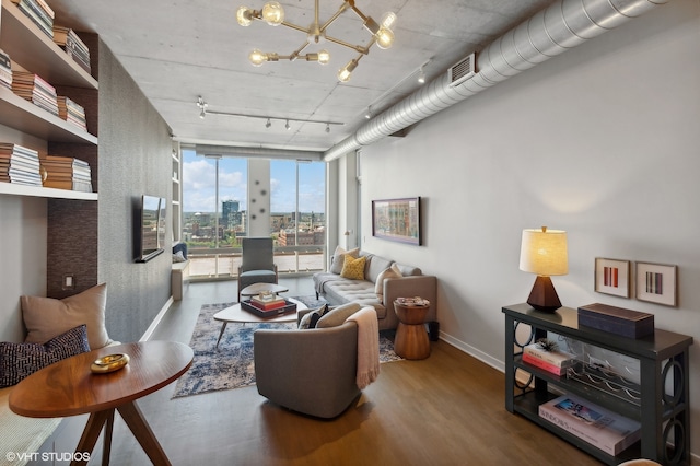 living room featuring floor to ceiling windows, track lighting, and hardwood / wood-style flooring