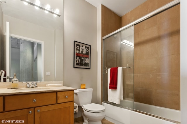 full bathroom featuring vanity, toilet, and combined bath / shower with glass door