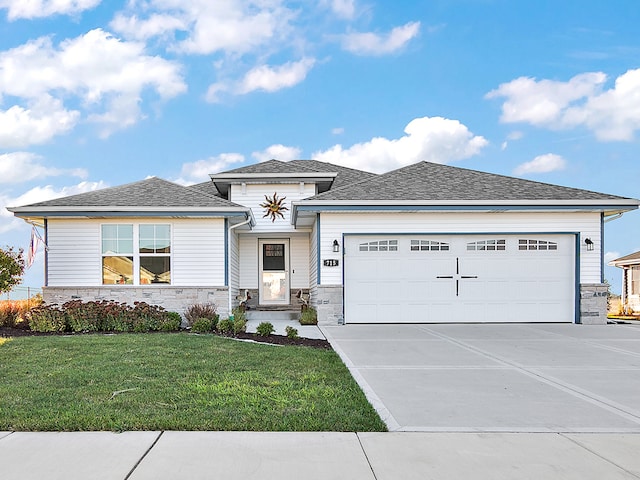 prairie-style house featuring a garage and a front yard