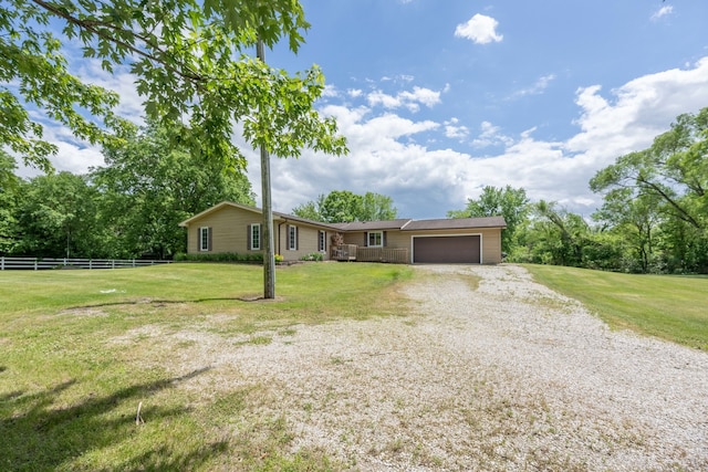 ranch-style home featuring a garage and a front lawn