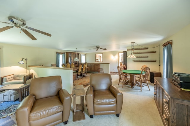 carpeted living room featuring ceiling fan