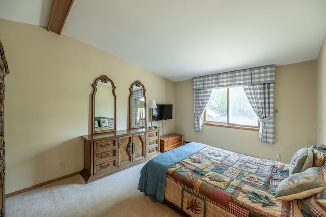 carpeted bedroom with vaulted ceiling with beams