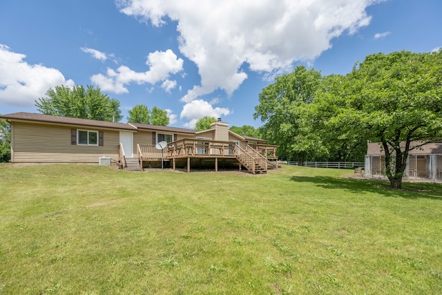 back of house with a yard and a wooden deck