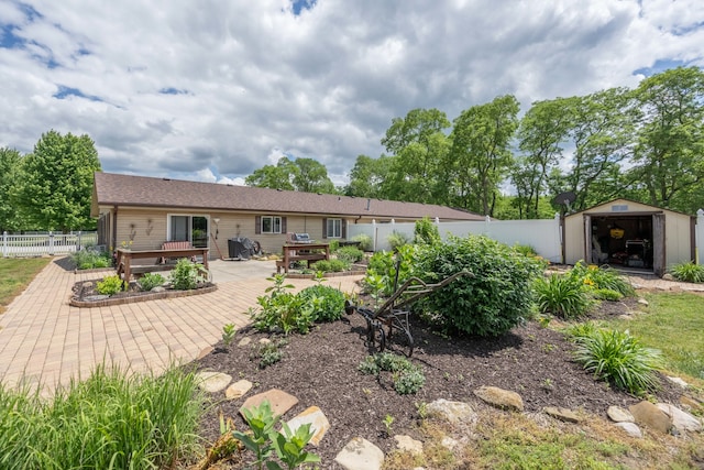 back of property featuring a storage shed and a deck