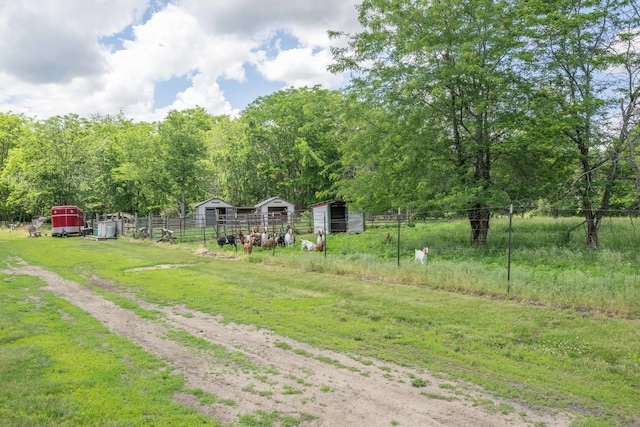 view of yard featuring a rural view and an outbuilding