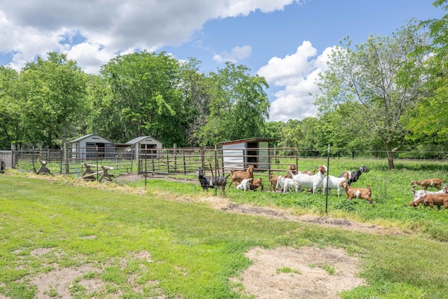 view of yard featuring an outdoor structure and a rural view