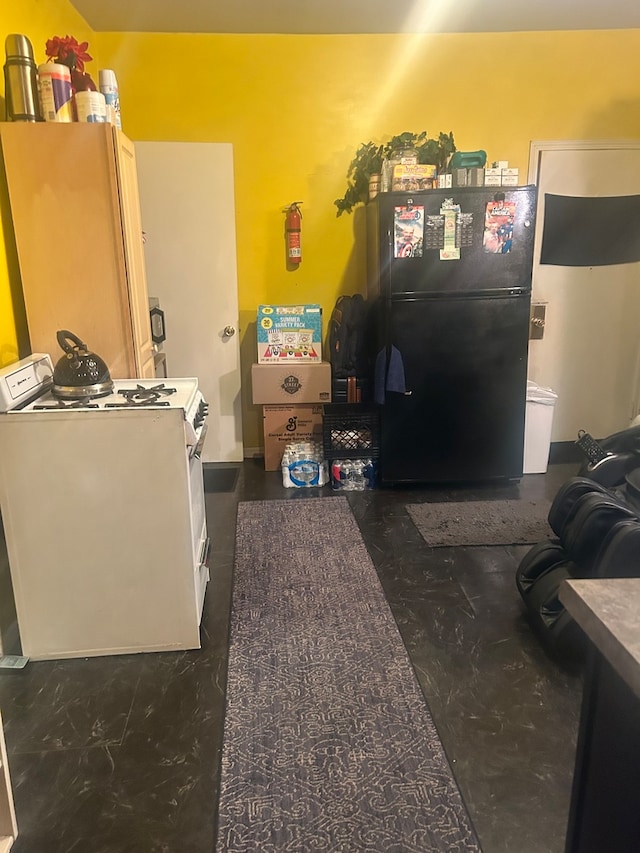 interior space featuring washer / dryer, white refrigerator, and black refrigerator