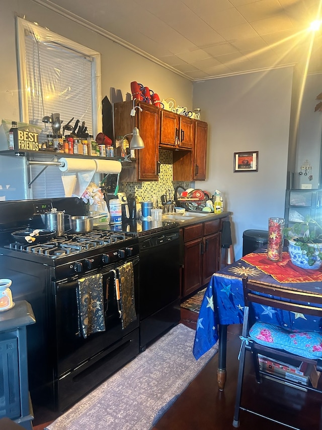 kitchen featuring crown molding, tasteful backsplash, and black appliances