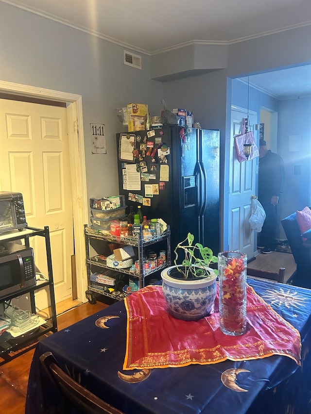 dining area with ornamental molding and wood-type flooring