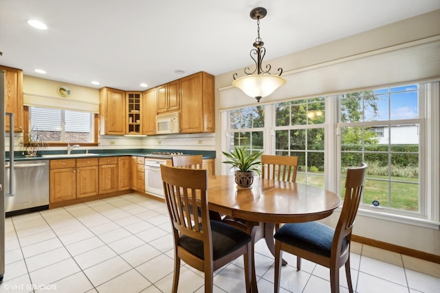 dining area featuring recessed lighting, baseboards, and light tile patterned flooring