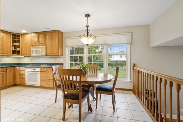 dining room with light tile patterned floors and baseboards