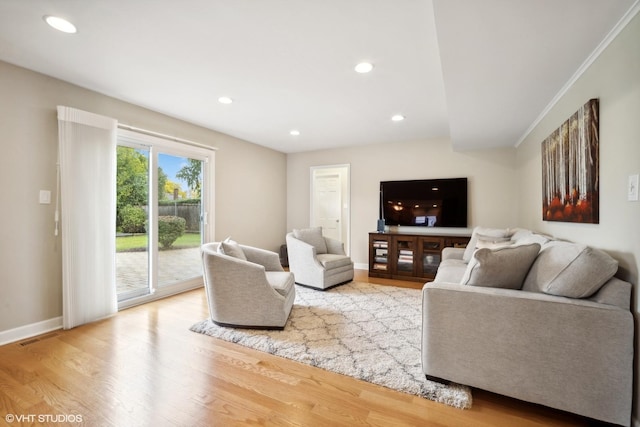 living area featuring recessed lighting, visible vents, baseboards, and wood finished floors