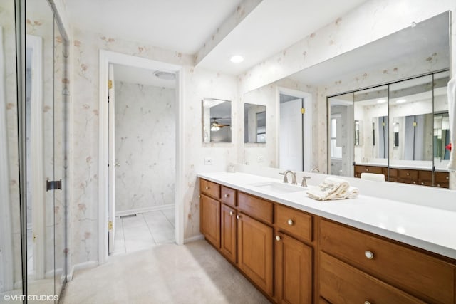 bathroom with baseboards, wallpapered walls, vanity, and a ceiling fan