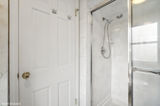 full bath featuring a shower stall