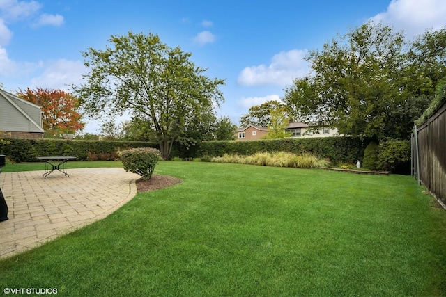 view of yard with fence and a patio area