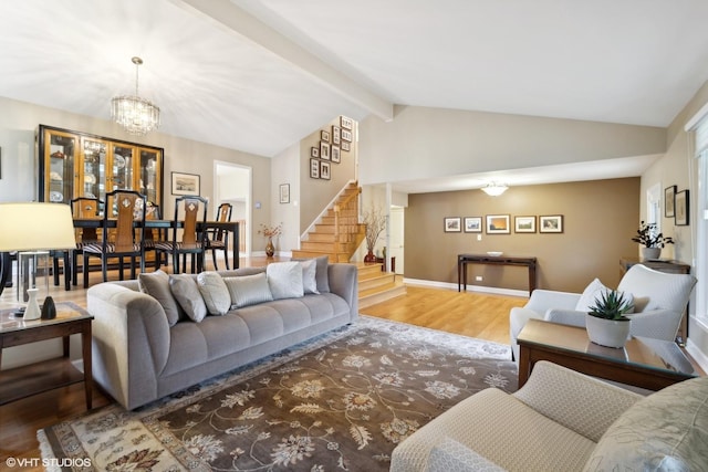 living area featuring baseboards, stairway, lofted ceiling with beams, an inviting chandelier, and wood finished floors