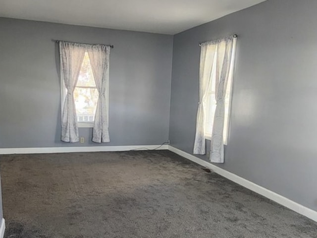 spare room featuring carpet