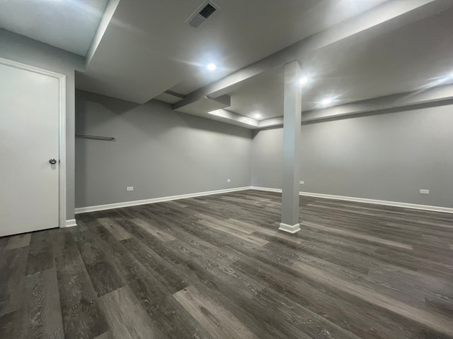 basement with dark hardwood / wood-style floors