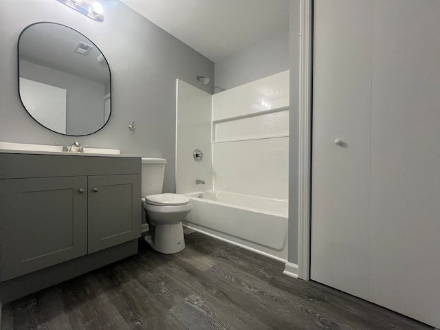 full bathroom with shower / bathing tub combination, wood-type flooring, vanity, and toilet