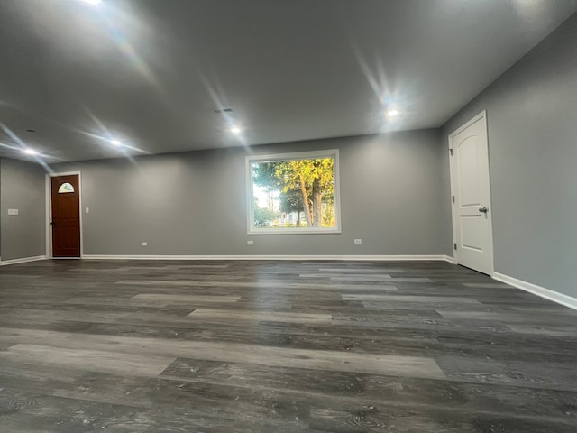 empty room with dark hardwood / wood-style flooring