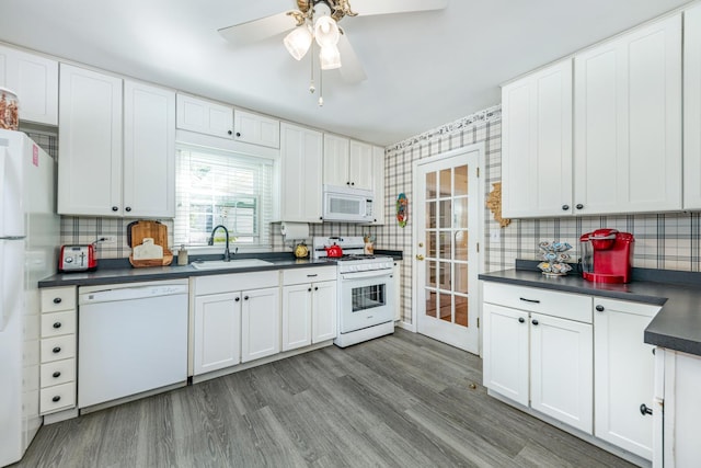 814 Countryside Dr, Wheaton, IL 60187 - kitchen featuring white appliances, dark countertops, a sink, a ceiling fan, and backsplash