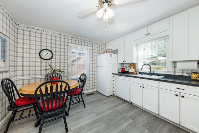 814 Countryside Dr, Wheaton, IL 60187 - kitchen with white appliances, wallpapered walls, a sink, dark countertops, and healthy amount of natural light