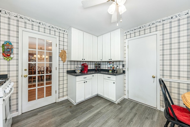 814 Countryside Dr, Wheaton, IL 60187 - kitchen featuring wallpapered walls, wood finished floors, dark countertops, white range with gas cooktop, and white cabinets
