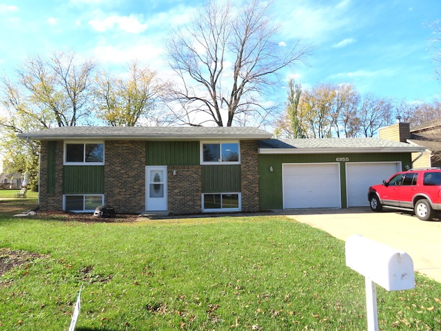 view of front of property with a garage and a front lawn