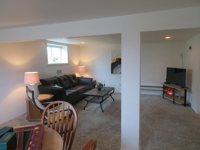 carpeted living room with a baseboard heating unit