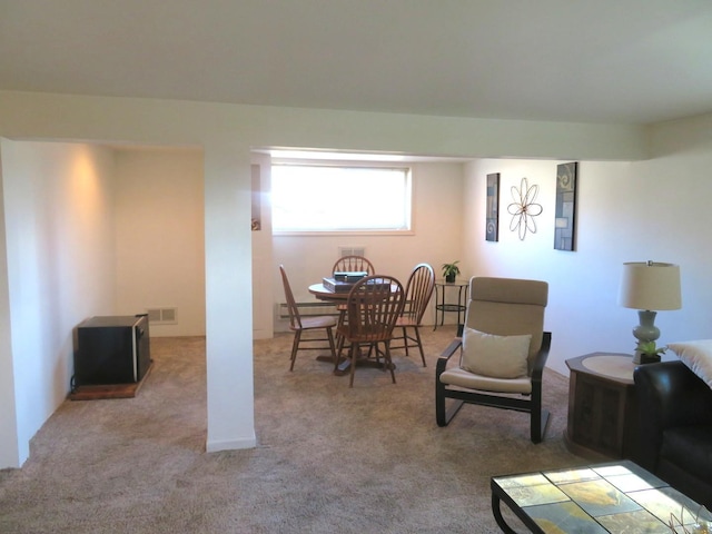 dining area with light colored carpet