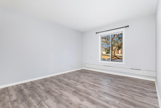 spare room featuring light hardwood / wood-style floors