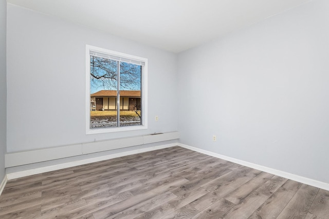 unfurnished room with wood-type flooring